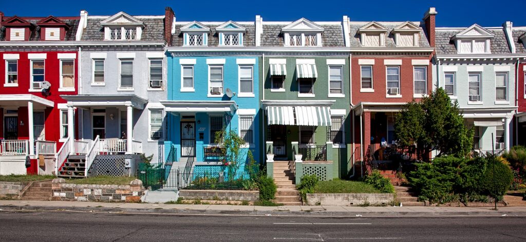A row of colorful townhouses available for buying in Washington, DC.